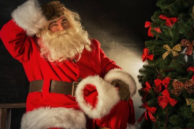Santa Claus brought gifts for Christmas. Sitting near Christmas tree and relaxing. Santa is tired ,model released, Symbolfoto