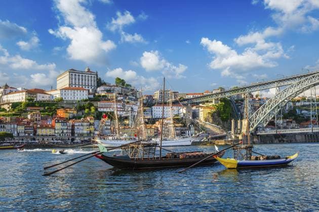 View of Porto city and Douro river with traditional boats with port wine barrels and sailing ship from famous tourist viewpoint Marginal de Gaia riverfront. Porto, Vila Nova de Gaia, Portugal, Europe *** View of Porto City and Douro River With Traditional Boats With Port Wine Barrels and Sailing Ship from Famous Tourist Viewpoint Marginal de Gaia Riverfront Postage, Vila Nova de Gaia, Portugal, Europe Copyright: imageBROKER DmitryxRukhlenko ibxdmr10916174.jpg RECORD DATE NOT STATED