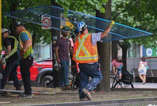 July 5, 2024, Montreal, Pq, Canada: A city worker carries part of a fence after police cleared a pro-Palestine protest encampment in Victoria Square in Montreal, Friday, July 5, 2024. Montreal Canada  - ZUMAc35_ 20240705_zaf_c35_033 Copyright: xGrahamxHughesx