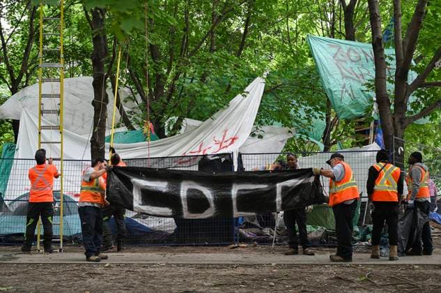 July 5, 2024, Montreal, Pq, Canada: City workers dismantle banners and tarps after police cleared a pro-Palestine protest encampment in Victoria Square in Montreal, Friday, July 5, 2024. Montreal Canada  - ZUMAc35_ 20240705_zaf_c35_036 Copyright: xGrahamxHughesx