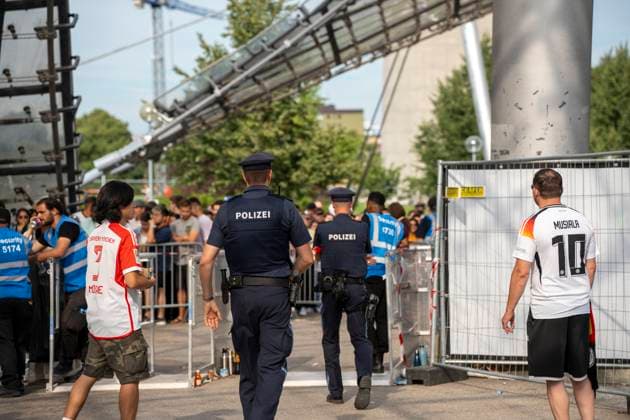 Munich, Bavaria, Germany - July 5, 2024: Police officers and security staff guard the entrance to the fan zone at the Olympic Park in Munich during the soccer match between Germany and Spain.