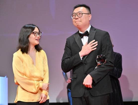 Chinese director Zhengfan Yang receives the Grand Prix of the Proxima Competition for his film The Stranger at the closing awards ceremony of the 58th Karlovy Vary International Film Festival, in Karlovy Vary, Czech Republic, on July 6, 2024. On the left is producer Shengze Zhu. (CTKxPhoto OndrejxHajek) CTKPhotoP2024070604832  CTKPhotoP2024070604832