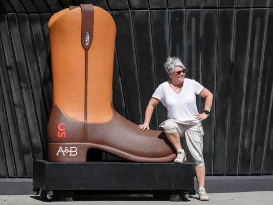July 6, 2024, Calgary, Ab, CANADA: A visitor poses next to an oversized cowboy boot at the Calgary Stampede in Calgary, Alta., Saturday, July 6, 2024. Calgary CANADA  - ZUMAc35_ 20240706_zaf_c35_004 Copyright: xJeffxMcintoshx