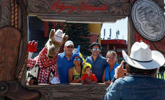 July 6, 2024, Calgary, Ab, CANADA: Visitors pose with mascot Harry the Horse at the Calgary Stampede sporting western duds in Calgary, Alta., Saturday, July 6, 2024. Calgary CANADA  - ZUMAc35_ 20240706_zaf_c35_007 Copyright: xJeffxMcintoshx