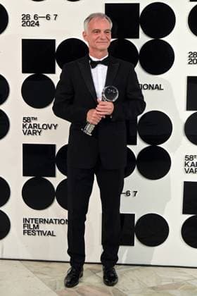 Actor Ivan Trojan poses in front the photo wall with his President s Award of Karlovy Vary International Film Festival for outstanding contribution to Czech cinema after the closing awards ceremony of the 58th Karlovy Vary International Film Festival, in Karlovy Vary, Czech Republic, on July 6, 2024. (CTKxPhoto SlavomirxKubes) CTKPhotoP2024070605447  CTKPhotoP2024070605447