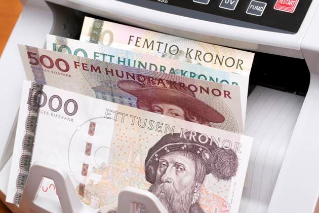 Swedish crown in the counting machine Swedish crown - krona in the counting machine Copyright: xZoonar.com JanuszxPienkowskix 21903499