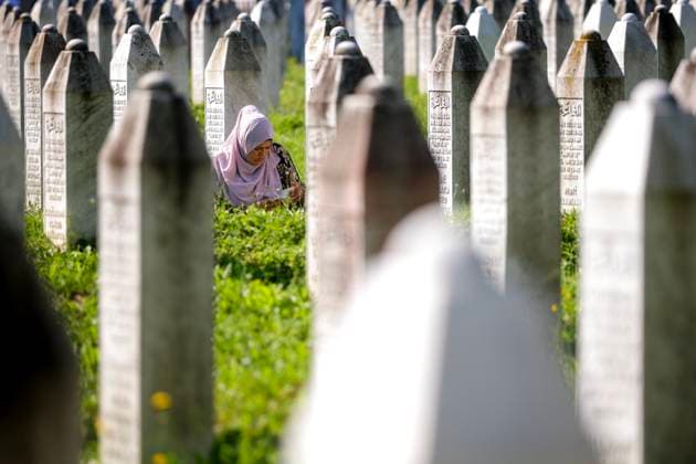 Srebrenica massacre 29th anniversary Muslim woman prays on a grave of her family members at the Potocari Genocide Memorial Center near Srebrenica, Bosnia and Herzegovina on July 11, 2024. Bosnia marks the 29th anniversary of the massacre of more than 8,000 Bosnian Muslim men and boys.  ArminxDurgut PIXSELL