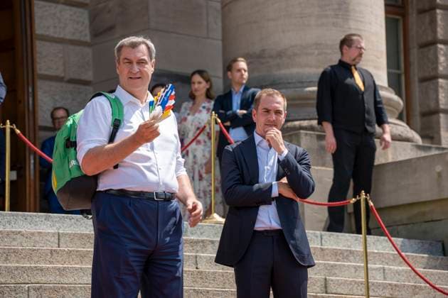 Munich, Bavaria, Germany: 11 July 2024: Dr. Markus Söder, Minister President of Bavaria, waves a UEFA fan because he is very hot. At the award ceremony for the volunteers of the UEFA Euro 2024 European Championship in Germany in Munich in the lower Hofgarten.