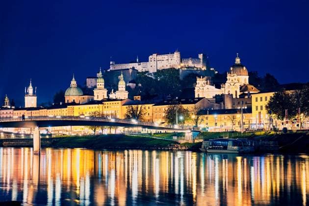 Salzburg city evening view. Cathedral, Old Town Altstadt, Hohensalzburg castle illuminated at night. Salzach River waterfront with promenade. Salzburg, Austria. Salzburg city evening view ,model released, Symbolfoto