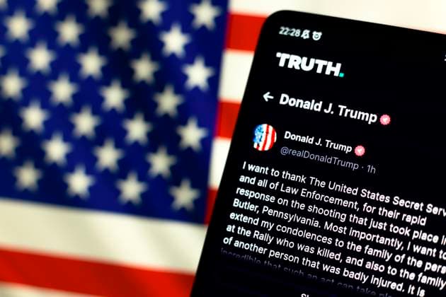 Photo illustration in Paraguay. In this photo illustration, the official profile of the former president of the United States Donald John Trump, seen on the social network Truth and in the background, the flag of the United States. The former president of U.S.A Donald John Trump, used his official profile on the Truth social network to say he was shot on the ear. Paraguay Copyright: xJaquexSilvax xSOPAxImagesx JAQUESILVA_13072024-4599