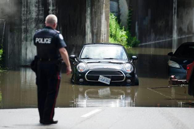 July 16, 2024, Toronto, On, Canada: Emergency services respond to submerged vehicles at an underpass at Parkside Drive and Lake Shore Blvd., after heavy rain caused flooding, in Toronto on Tuesday, July 16, 2024. Toronto Canada  - ZUMAc35_ 20240716_zaf_c35_041 Copyright: xChristopherxKatsarovx