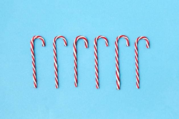 christmas and winter holidays concept - candy cane decorations on blue background. candy cane decorations on blue background ,model released, Symbolfoto
