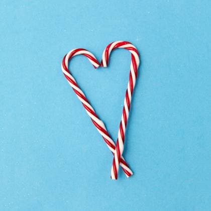 christmas and winter holidays concept - candy cane decorations in shape of hearts on blue background. candy cane decorations in shape of hearts ,model released, Symbolfoto