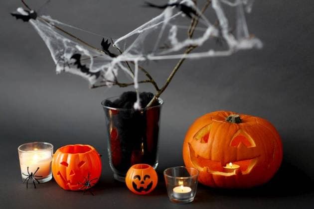 halloween and holiday concept - jack-o-lantern or carved pumpkin, burning candles and spider web decoration. pumpkins, candles and halloween decorations ,model released, Symbolfoto