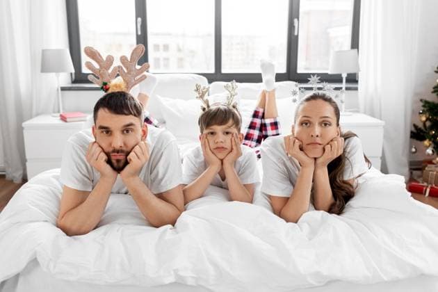 family, winter holidays and people concept - sad mother, father and little son in bed in christmas morning. sad family in bed in christmas morning ,model released, Symbolfoto