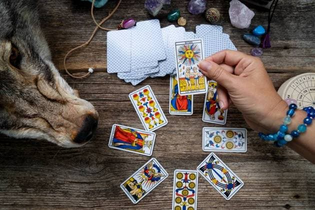 Fortune telling on tarot cards, witch hand is opening cards, used Marseille Tarot deck by unknown artist published first in 1709. Fortune telling on tarot cards ,model released, Symbolfoto