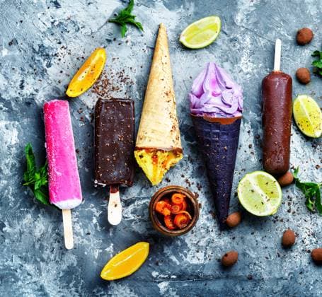Different types of ice cream in a waffle cone and popsicle. Assorted ice cream ,model released, Symbolfoto