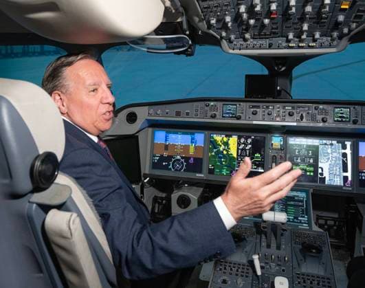 July 23, 2024, Montreal, Pq, Canada: Quebec Premier Francois Legault tries a flight simulator at the Airbus A220 manufacturing facility in Mirabel, Que., Tuesday, July 23, 2024. The Quebec government is investing $410 million to increase production at the plant. Montreal Canada  - ZUMAc35_ 20240723_zaf_c35_018 Copyright: xRyanxRemiorzx