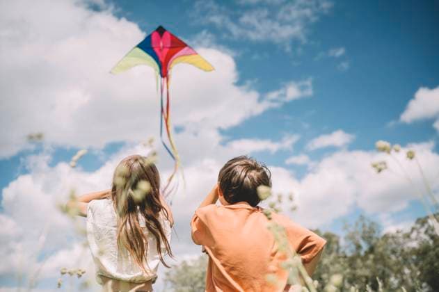 Creative Highlights Symbolfotos Girl flying kite by brother on sunny day model released, Symbolfoto, ANAF03274