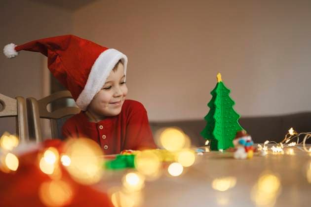 Happy boy looking at clay Christmas tree on table model released, Symbolfoto, ASVF00101