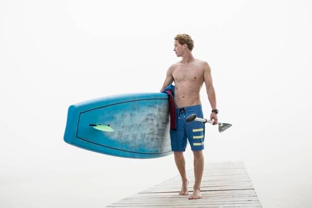 Creative Highlights Symbolfotos Shirtless man carrying paddleboard and oar on jetty in foggy weather model released, Symbolfoto, PNEF03462