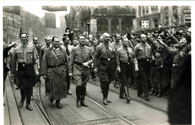 RECORD DATE NOT STATED Hitler marching with Goering and others in uniform In the entre of the marching column are Goering and Hitler. The date is 9 November 1933, just 9 Months after Hitlers appointment as Chancellor. The place is Munich. When those two men had marched together in that same city in 1923, ten years earlier to the day, they had been fired upon by the police. Goering had been wounded and had fled to Austria. Hitler was captured, tried and imprisoned. Now they were effectively the two most powerful men in Germany. It must have been an intoxicating experience for them. Date: 1933  Copyright: Copyrightx(c)Geminix2023.xCredit:xGemini 13140232