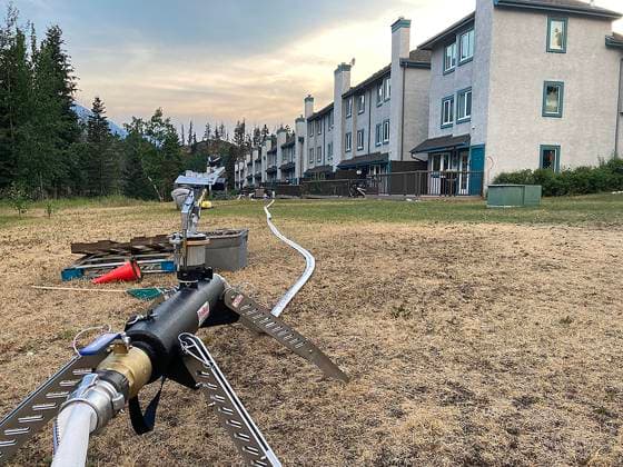 July 25, 2024, , Alberta, Canada: A water hose for structural protection is set up near housing in the town of Jasper. Wildfires have spread through , causing significant loss within the local town, according to park officials. More than 25,000 people were told to evacuate the area earlier this week, officials said. Jasper National Park Canada  - ZUMA 20240725_new_z03__036 Copyright: xJasperxNationalxParkx