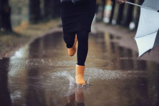 feet in rubber boots rain puddle city ,model released, Symbolfoto