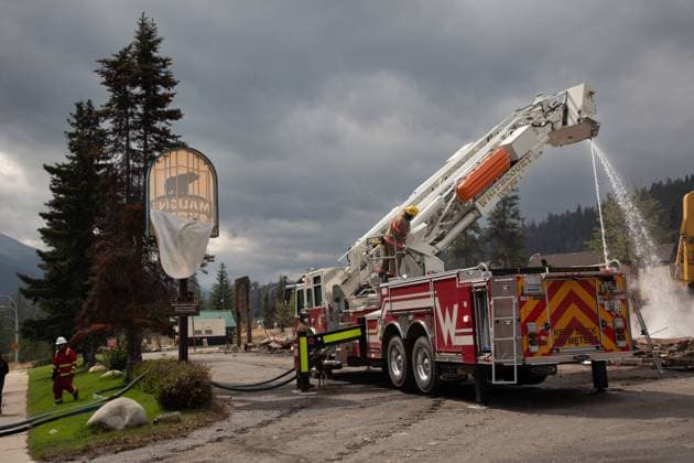 July 26, 2024, Jasper, Ab, CANADA: Fire crews work to put out hotspots in the Maligne Lodge in Jasper, Alta., on Friday July 26, 2024. Wildfires encroaching into the townsite of Jasper forced an evacuation of the national park and have destroyed over 300 of the town s approximately 1100 structures, mainly impacting residential areas. Jasper CANADA  - ZUMAc35_ 20240726_zaf_c35_177 Copyright: xAmberxBrackenx