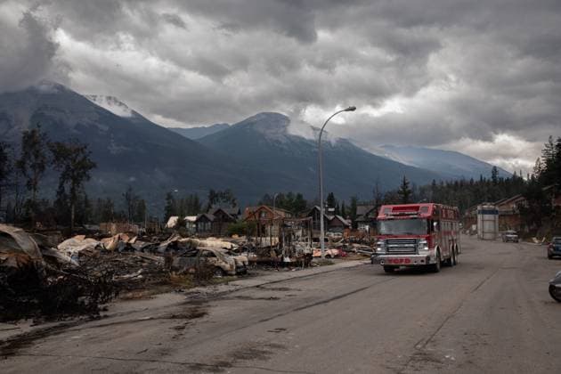 July 26, 2024, Jasper, Ab, CANADA: A fire truck travels past a devastated residential block in Jasper, Alta., on Friday July 26, 2024. Wildfires encroaching into the townsite of Jasper forced an evacuation of the national park and have destroyed over 300 of the town s approximately 1100 structures, mainly impacting residential areas. Jasper CANADA  - ZUMAc35_ 20240726_zaf_c35_184 Copyright: xAmberxBrackenx