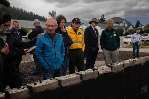 July 26, 2024, Jasper, Ab, CANADA: Jasper Mayor Richard Ireland, second left in blue, looks at what is left of his home of 67 years with federal Minister of Emergency Preparedness Harjit Sajjan, left to right, Premier Danielle Smith, and Minister of Forestry and Parks Todd Loewen in Jasper, Alta., on Friday, July 26, 2024. Wildfires encroaching into the townsite of Jasper forced an evacuation of the national park and have destroyed over 300 of the town s approximately 1100 structures, mainly impacting residential areas. Jasper CANADA - ZUMAc35_ 20240726_zaf_c35_217 Copyright: xAmberxBrackenx