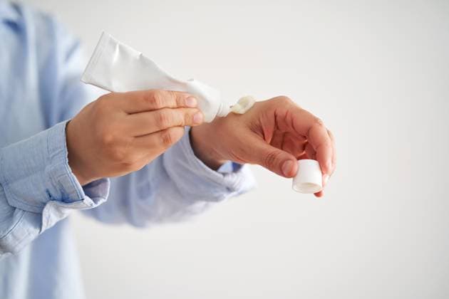 Hands in a blue shirt hold a tube of cream. Hands in a blue shirt hold a tube of cream. High quality photo. Copyright: xZoonar.com borisovaxmarevgennax 21682080