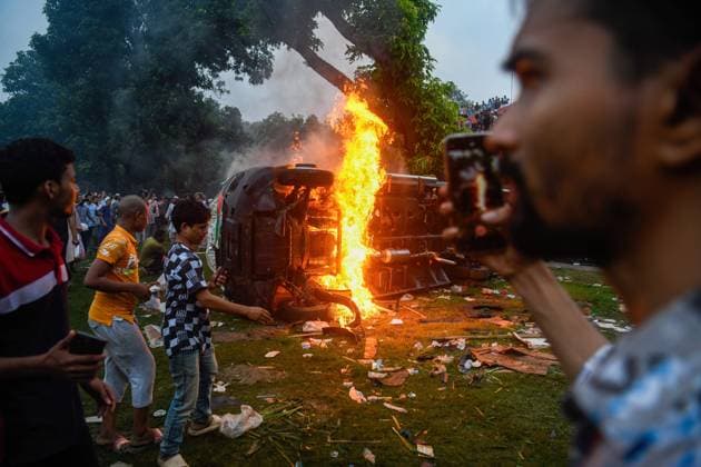 August 5, 2024, Dhaka, Bangladesh: A car seen on fire inside the Ganobhaban during the celebration at the country s Prime Minister Sheikh Hasina s residence after she fled and resigned. Thousands of People celebrate the resignation of Bangladeshi Prime Minister Sheikh Hasina. Protests in Bangladesh that began as student-led demonstrations against government hiring rules in July culminated on August 5, in the Prime Minister fleeing and the military announcing it would form an interim government. Dhaka Bangladesh - ZUMAs197 20240805_aaa_s197_092 Copyright: xPiyasxBiswasx