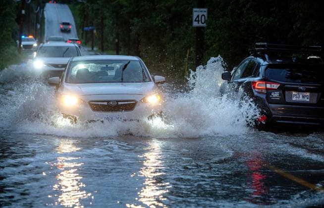 August 9, 2024, Montreal, Pq, CANADA: Cars drive slowly through flooded streets in Sainte-Anne-de-Bellevue on the island of Montreal after heavy rains hit the area on Friday, August 9, 2024. Montreal CANADA  - ZUMAc35_ 20240809_zaf_c35_174 Copyright: xPeterxMccabex