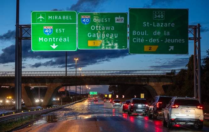 August 9, 2024, Montreal, Pq, CANADA: Vehicles drive slowly through water overflowing on to highway 30 in Vaudreuil-Dorion west of Montreal after heavy rains hit the area on Friday, August 9, 2024. Montreal CANADA  - ZUMAc35_ 20240809_zaf_c35_175 Copyright: xPeterxMccabex