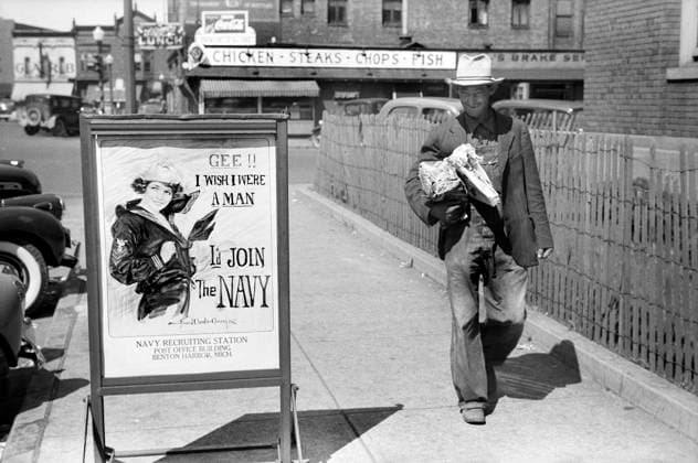 Migrant Worker walking by U.S. Navy Recruitment Poster, Benton Harbor, Michigan, USA, John Vachon, U.S. Farm Security Administration July 1940  Copyright: xCircaxImagesx ghi-circa02543