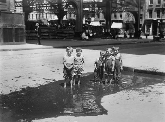 Group of Small Boys standing in Street Puddle, New York City, New York, USA, Bain News Service, July 1913  Copyright: xCircaxImagesx ghi-circa02817