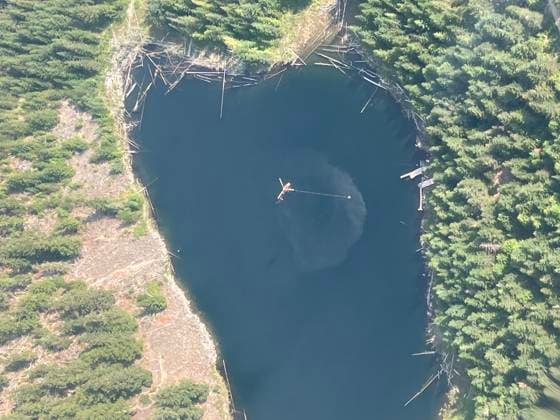 (240813) -- BRITISH COLUMBIA (CANADA), Aug. 13, 2024 -- Aerial photo provided by shows a firefighting helicopter collecting water to drop over a wildfire near Rutherford Creek, British Columbia, Canada, on Aug. 12, 2024. There are 428 active wildfires across British Columbia in Canada, according to . ( Handout via Xinhua) CANADA-BRITISH COLUMBIA-WILDFIRES BCxWildfirexService 