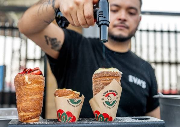 August 14, 2024, Toronto, On, Canada: Eva s Original Chimneys staff prepare their croÂ¨me broÂ»lo e cones on media preview day at the Canadian National Exhibition in Toronto on Wednesday, August 14, 2024. Toronto Canada  - ZUMAc35_ 20240814_zaf_c35_027 Copyright: xLauraxProctorx