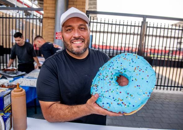 August 14, 2024, Toronto, On, Canada: Tito Aguilar holds up a family-sized doughnut on media preview day at the Canadian National Exhibition in Toronto on Wednesday, August 14, 2024. Toronto Canada  - ZUMAc35_ 20240814_zaf_c35_034 Copyright: xLauraxProctorx