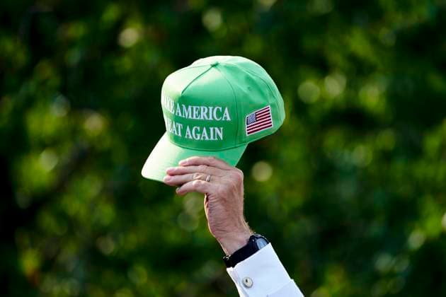 An attendee holds a hat during a press conference at Trump National Golf Club in Bedminster, New Jersey on Thursday, August 15, 2024. The former president s family business is seeking to build residences and retail inside the Trump National Doral Miami resort, according to documents posted on a City of Doral website.  WAX20240815260 BingxGuan