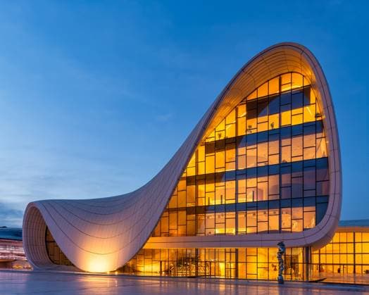 Creative Highlights World Evening View of Heydar Aliyev Centre in Baku Azerbaijan With Illuminated Exteriors The Heydar Aliyev Centre in Baku, Azerbaijan, glows warmly in the night with its unique, flowing architecture Copyright: xZoonar.com KHALEDxELADAWYx 21990225