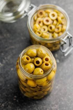 Pickled green olives in brine on black table. Pickled green olives in brine on a black table. Copyright: xZoonar.com JirixHERAx 22015691