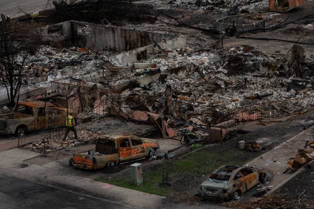 August 19, 2024, Jasper, Ab, CANADA: A worker walks in a devastated neighbourhood in west Jasper, Alberta on Monday August 19, 2024. Wildfire caused evacuations and widespread damage in the National Park and Jasper townsite. Jasper CANADA  - ZUMAc35_ 20240819_zaf_c35_050 Copyright: xAmberxBrackenx