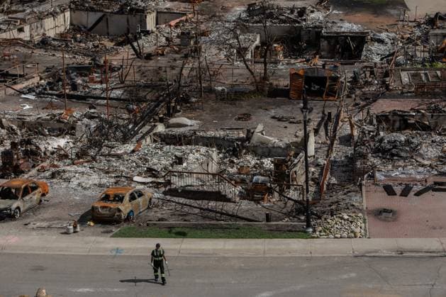 August 19, 2024, Jasper, Ab, CANADA: A worker walks in a devastated neighbourhood in west Jasper, Alberta on Monday August 19, 2024. Wildfire caused evacuations and widespread damage in the National Park and Jasper townsite. Jasper CANADA  - ZUMAc35_ 20240819_zaf_c35_051 Copyright: xAmberxBrackenx