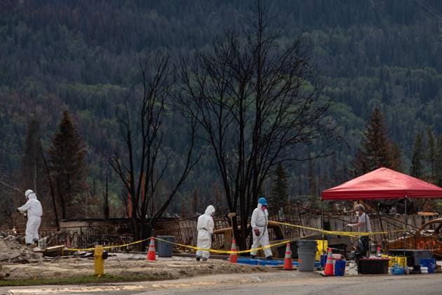 August 19, 2024, Jasper, Ab, CANADA: Workers sift through the ashes of a home as the homeowner looks on and gives directions in Jasper, Alberta on Monday August 19, 2024. Wildfire caused evacuations and widespread damage in the National Park and Jasper townsite. Jasper CANADA  - ZUMAc35_ 20240819_zaf_c35_082 Copyright: xAmberxBrackenx