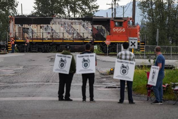 August 22, 2024, Surrey, Bc, CANADA: Locked out Canadian National Rail workers stand at a picket line as locomotives are moved by management at CN Rail s Thornton Yard, in Surrey, B.C., on Thursday, August 22, 2024. In the culmination of months of increasingly bitter negotiations, Canadian National Railway Co. and Canadian Pacific Kansas City Ltd. locked out 9,300 engineers, conductors and yard workers after the parties failed to agree on a new contract before the midnight deadline. Surrey CANADA - ZUMAc35_ 20240822_zaf_c35_192 Copyright: xDarrylxDyckx