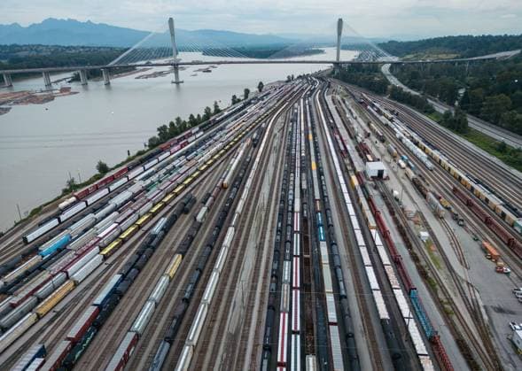August 22, 2024, Surrey, British Columbia, CANADA: Train cars are seen on the tracks in an aerial view at Canadian National Rail s Thornton Yard as the Port Mann Bridge spans the Fraser River, on Thursday. In the culmination of months of increasingly bitter negotiations, Canadian National Railway Co. and Canadian Pacific Kansas City Ltd. locked out 9,300 engineers, conductors and yard workers after the parties failed to agree on a new contract before the midnight deadline. Surrey Canada  - ZUMAc35_ 20240822_zaf_c35_146 Copyright: xDarrylxDyckx