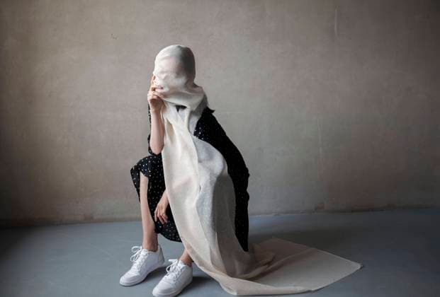 Creative Highlights Symbolbilder Woman covered with fabric sitting in room at home model released, Symbolfoto, VCF00167