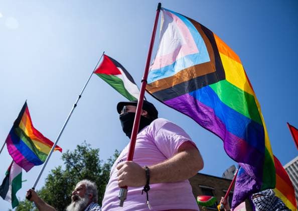 August 25, 2024, Ottawa, On, Canada: Marchers wave the Palestinian flag and pride flags as they walk in the Capital Pride Parade in Ottawa, on Sunday, August 25, 2024. Ottawa Canada  - ZUMAc35_ 20240825_zaf_c35_028 Copyright: xChrisxTanouyex